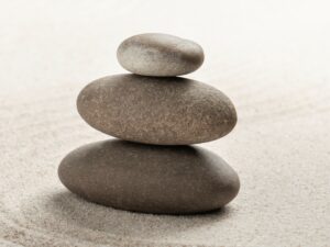Stacked zen stones sand background art of balance concept